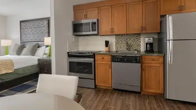 a kitchen with stainless steel appliances and a bed at Marriott Grand Residence Luxury Studio sleeps 2 in South Lake Tahoe