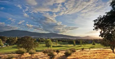a view of a golf course with mountains in the background at WorldMark Angels Camp - 1BD in Angels Camp