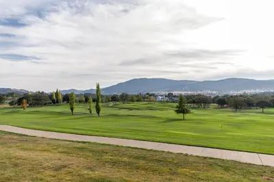 a view of a golf course with trees and a sidewalk at WorldMark Angels Camp - 1BD in Angels Camp