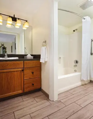 a bathroom with a tub and a sink and a mirror at WorldMark Angels Camp - 1BD in Angels Camp