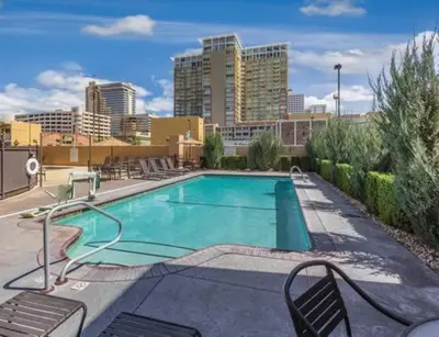 a swimming pool with a city skyline in the background at Great 1BD condo with resort amenities take in all Reno has to offer in Reno