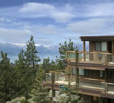 a building with a balcony with mountains in the background at Worldmark Lake Tahoe - 1BD Sleeps up to 4 in Stateline