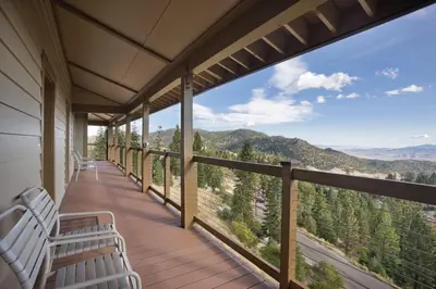 a balcony with white chairs and a view of the mountains at Worldmark Lake Tahoe - 2BD Sleeps up to 6 in Stateline
