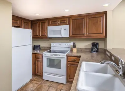 a kitchen with white appliances and wooden cabinets at Worldmark Lake Tahoe - 2BD Sleeps up to 6 in Stateline