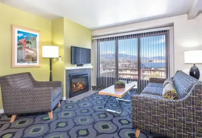 a living room with two chairs and a fireplace at Enjoy all Reno has to offer in this 2BD resort condo with outdoor pool or hot tub in Reno