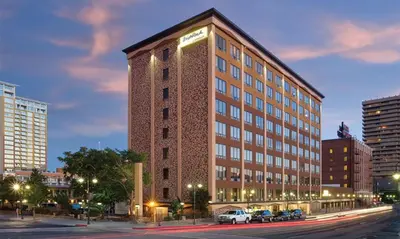 a tall building with cars parked in front of it at Enjoy all Reno has to offer in this 2BD resort condo with outdoor pool or hot tub in Reno
