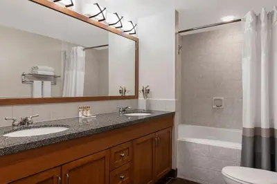 a bathroom with a sink and a toilet and a tub at Marriott Grand Residences Luxury 1BD in South Lake Tahoe
