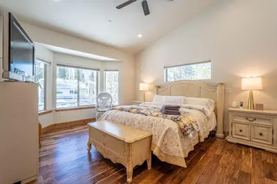 a bedroom with a large bed and a tv at CHALET LU - Modern Luxury 4 bed 2.5 bath Chalet by Lake Baron in South Lake Tahoe in South Lake Tahoe