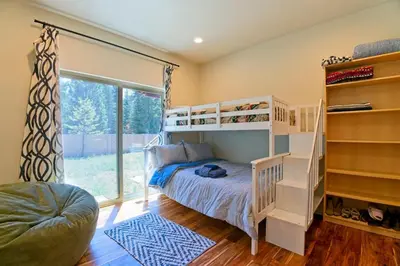 a bedroom with a bunk bed and a large window at CHALET LU - Modern Luxury 4 bed 2.5 bath Chalet by Lake Baron in South Lake Tahoe in South Lake Tahoe