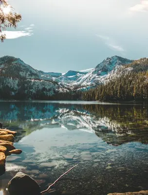 a view of a lake with snow covered mountains at CHALET LU - Modern Luxury 4 bed 2.5 bath Chalet by Lake Baron in South Lake Tahoe in South Lake Tahoe