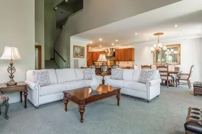 a living room with white couches and a table at Snowcreek IV 525 in Mammoth Lakes