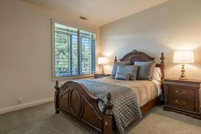 a bedroom with a large bed and a window at Snowcreek IV 525 in Mammoth Lakes