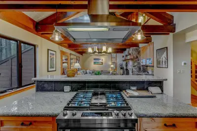 a kitchen with a stove top oven in a room at Alpine Meadows Retreat 3 Min to Base with Hot Tub in Alpine Meadows