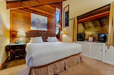 a bedroom with a large bed and a desk at Alpine Meadows Retreat 3 Min to Base with Hot Tub in Alpine Meadows