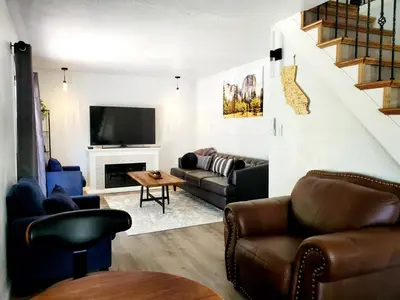a living room with a couch and a television at -Serendipity Lodge at Yosemite- BBQ-Full Kitchen-King Bed in Oakhurst