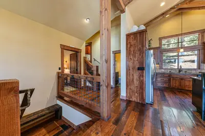 a kitchen with wooden floors and a refrigerator at Compass Luxury Lodge - Access to HOA and Free Shuttle! in Truckee
