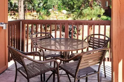 a table and chairs sitting on a porch with a table and chairs at Wyndham South Shore 1Bd- sleeps 4 in Zephyr Cove