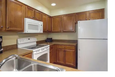 a kitchen with wooden cabinets and a white refrigerator at Worldmark South Shore 1Bd- sleeps 4 in Zephyr Cove