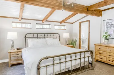 a bedroom with a bed and a wooden ceiling at The Valley View- Pine Mountain Lake Cabin home in Groveland