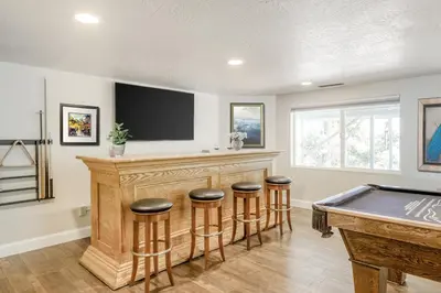 a home bar with a pool table and stools at The Valley View- Pine Mountain Lake Cabin home in Groveland