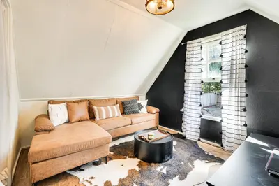 a living room with a couch and a window at Hike, Ski and Fish Charming Cabin in Twain Harte! in Twain Harte