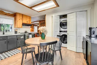 a kitchen with a wooden table and chairs at Hike, Ski and Fish Charming Cabin in Twain Harte! in Twain Harte