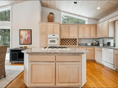 a kitchen with wooden cabinets and a counter top at The Royal Canterbury Retreat - Near Kings Beach & Lake Tahoe in Kings Beach