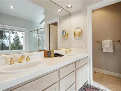 a bathroom with two sinks and a large mirror at The Royal Canterbury Retreat - Near Kings Beach & Lake Tahoe in Kings Beach