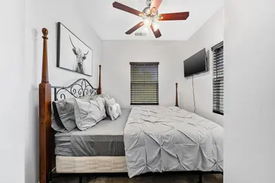 a bedroom with a bed and a ceiling fan at Cozy 2bdr, 1br home near downtown in Sacramento