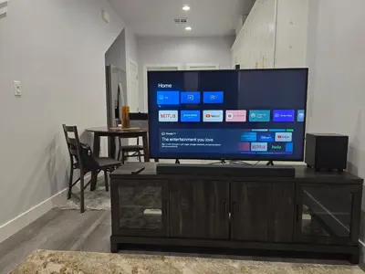 a flat screen tv sitting on top of a entertainment center at Cozy 2bdr, 1br home near downtown in Sacramento