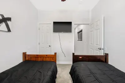 a bedroom with a bed and a flat screen tv at Cozy 2bdr, 1br home near downtown in Sacramento