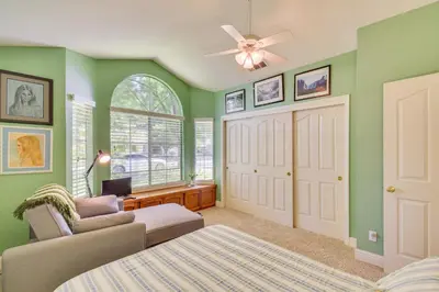 a bedroom with green walls and a ceiling fan at 1 Mi to Applegate Park Zoo Pet-Friendly Home in Merced