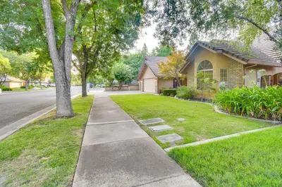a sidewalk in front of a house at 1 Mi to Applegate Park Zoo Pet-Friendly Home in Merced