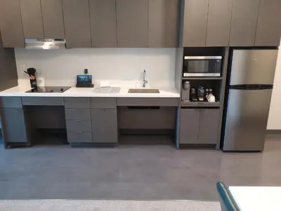 an empty kitchen with a sink and a refrigerator at My TRI Suites Reno Sparks in Clark