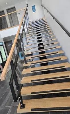 a staircase in a building with wood and metal steps at My TRI Suites Reno Sparks in Clark
