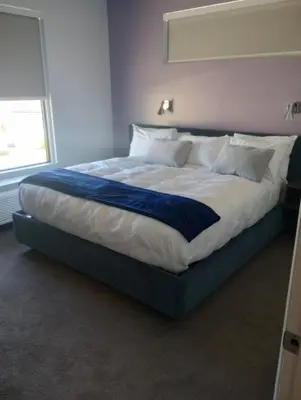 a large bed in a bedroom with a window at My TRI Suites Reno Sparks in Clark