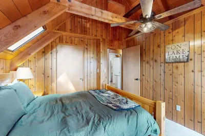 a bedroom with a bed and a ceiling fan at Lakeview Cabin in Tahoma