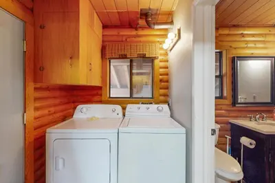 a white washer and dryer in a bathroom at Lakeview Cabin in Tahoma