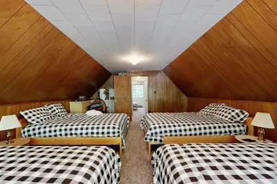 a room with three beds with checkered sheets at 3 Mi to State Park Quiet Escape with Deck in Arnold in Dorrington