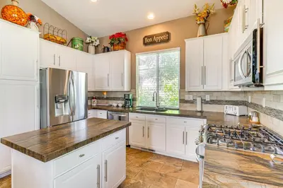 a kitchen with white cabinets and a counter top at Game Room and Fireplace Reno Home 5 Mi to Dtwn! in Reno