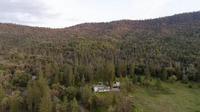 an aerial view of a house in the middle of a forest at Pool-GameRoom-HomeTheater-Bar-PlayStructure-FirePit in Oakhurst