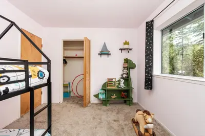 a bedroom with a bunk bed and a window at Pool-GameRoom-HomeTheater-Bar-PlayStructure-FirePit in Oakhurst