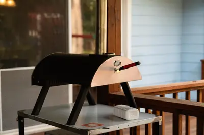 a black chair sitting on a table on a porch at Pool-GameRoom-HomeTheater-Bar-PlayStructure-FirePit in Oakhurst