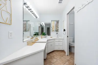 a bathroom with two sinks and a large mirror at Pool-GameRoom-HomeTheater-Bar-PlayStructure-FirePit in Oakhurst