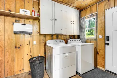 a laundry room with a washer and dryer and cabinets at Walk to Winery Cozy Cabin with Fire Pit in Murphys in Murphys