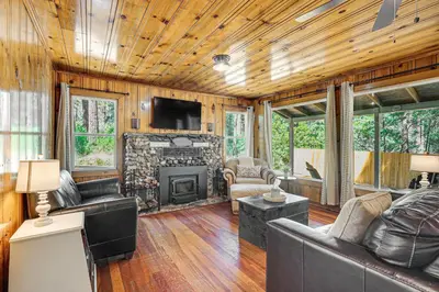 a living room with a couch and a fireplace at Walk to Winery Cozy Cabin with Fire Pit in Murphys in Murphys