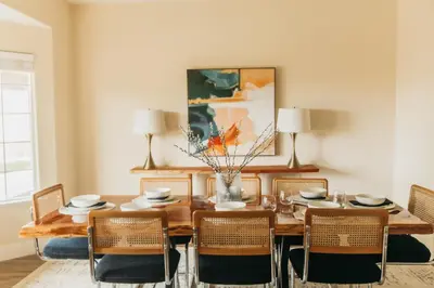 a dining room with a wooden table and chairs at Panoramic Lookout Sierra Serenity BBQ by CasaOso in Mariposa