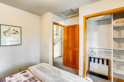 a bedroom with a bed and a wooden door at Deck with Mountain Views Cabin in Bear Valley! in Bear Valley