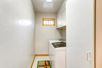 a small kitchen with a washer and dryer at Deck with Mountain Views Cabin in Bear Valley! in Bear Valley
