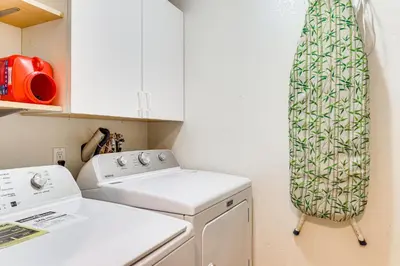 a kitchen with a washing machine and a towel at Forest-View Haven with Game Room Tahoe City Gem! in Tahoe City